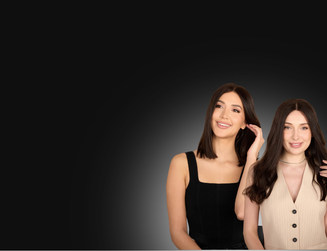 Two women standing side by side against a dark background